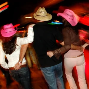 Dancing trio with pink hats