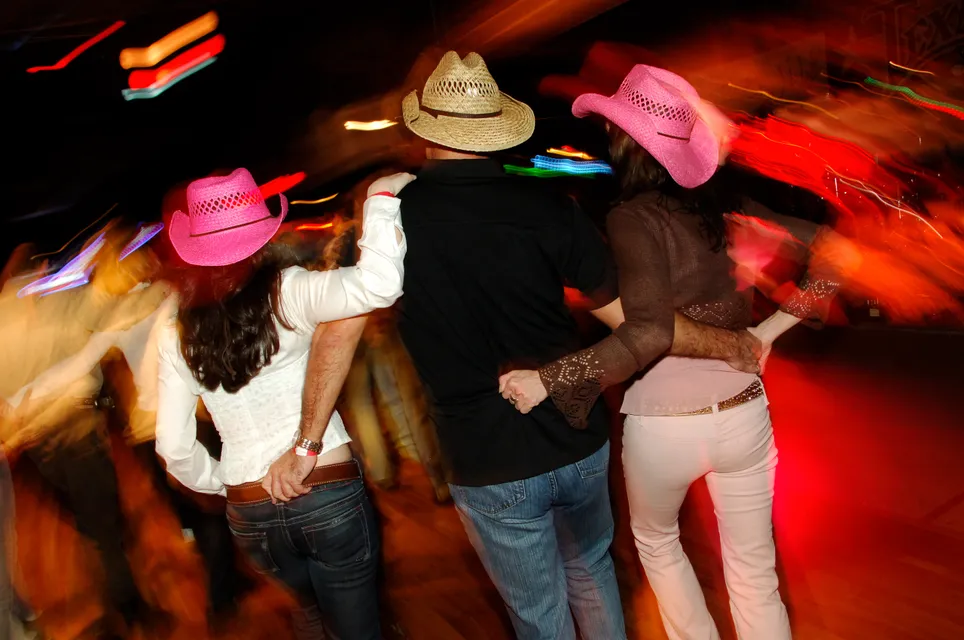 Dancing trio with pink hats