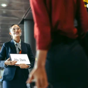 Airport greeter with a sign